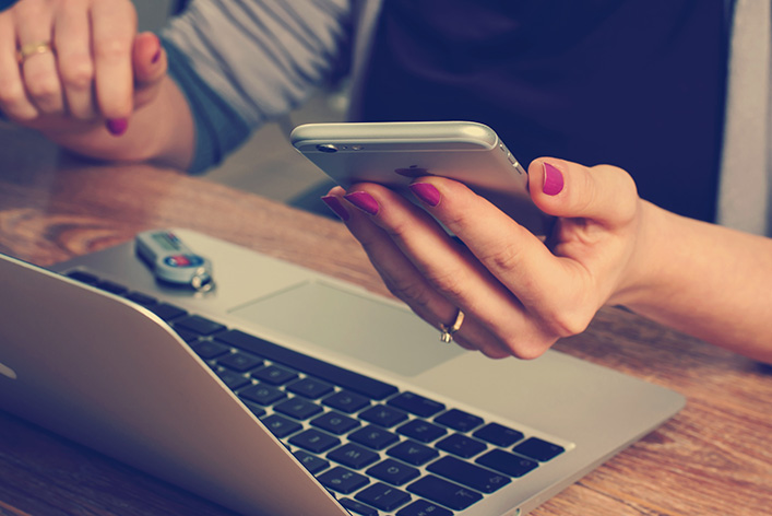 Woman working on a laptop and mobile phone. NYTLicensing.