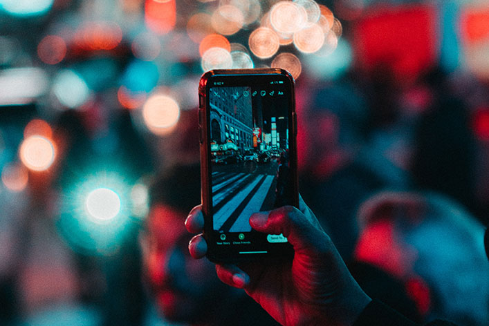 Man shoots a video for a social media post. 