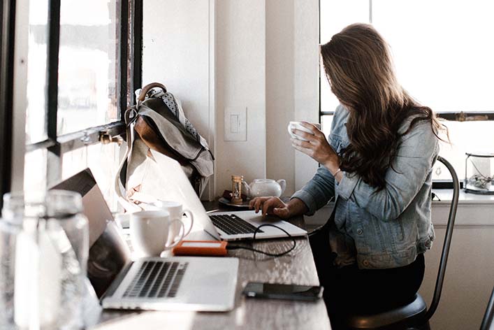 Woman works in the office on a laptop.