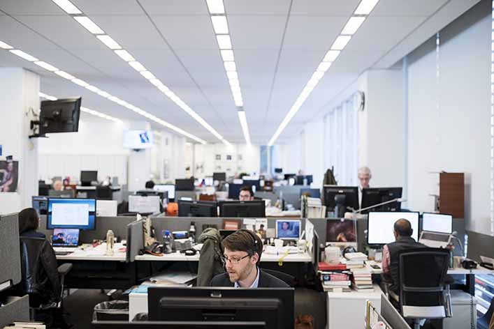 A man works at his computer in an office. Digital marketing can help you reach your target audience and generate leads.