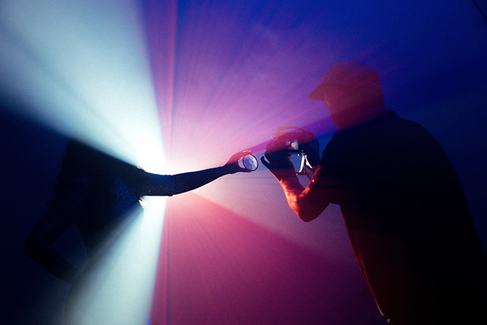 Man shoots photography with a handheld lens. NYTLicensing.