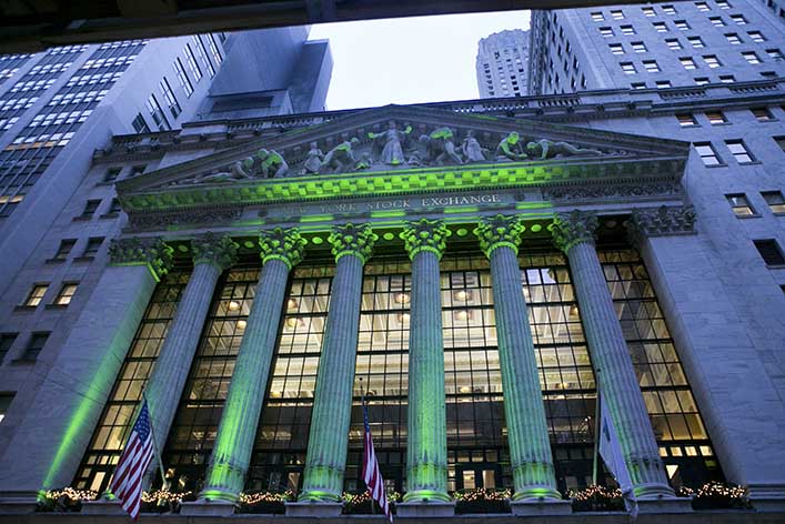 The New York Stock Exchange is uplit in green. Content marketing is essential to a financial marketing strategy. 