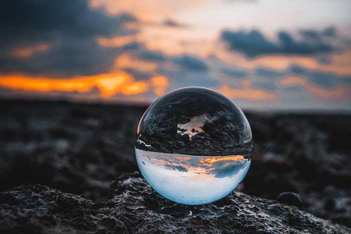 A glass sphere on a beach.