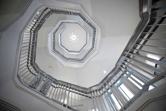 A white spiral staircase seen from the bottom floor. Content marketing can be used to grow your business and brand.