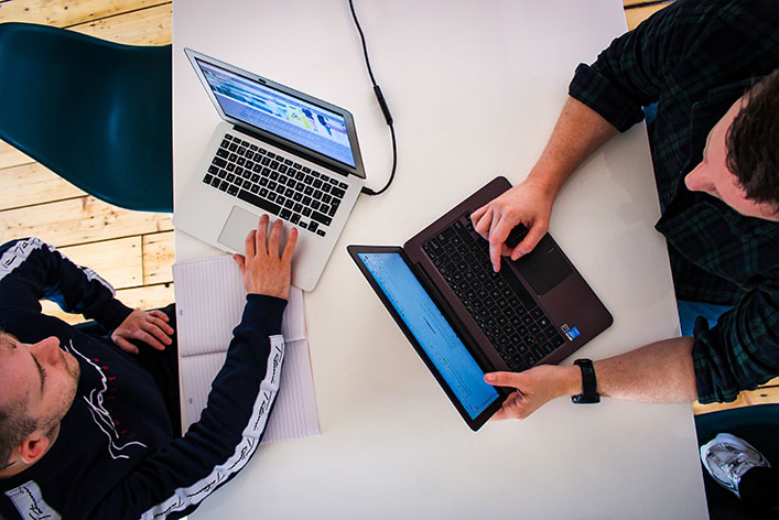 Two people coworking at their laptops.