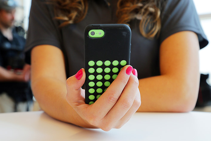 A woman checks content on her mobile phone. Content curation offers readers useful information from a variety of sources.